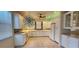 Kitchen with white cabinets, unique light fixture, and colorful lighting accents at 197 Tropicana Dr # 1512, Punta Gorda, FL 33950