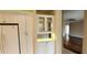 Bright kitchen with white cabinetry, glass-front cabinets, and a view to the living area at 197 Tropicana Dr # 1512, Punta Gorda, FL 33950