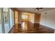 Spacious living area with wood-look flooring, ceiling fan, and access to the kitchen and dining area at 197 Tropicana Dr # 1512, Punta Gorda, FL 33950