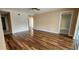 Living room with wood-look floors, neutral walls, and doorway to another room at 197 Tropicana Dr # 1512, Punta Gorda, FL 33950