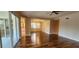 Open living and dining area with wood-look floors, ceiling fan, and sliding glass doors at 197 Tropicana Dr # 1512, Punta Gorda, FL 33950