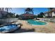 Community pool with hot tub, lounge chairs, and paved deck at 197 Tropicana Dr # 1512, Punta Gorda, FL 33950