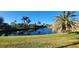 Community waterfront with palm trees and lush grass at 197 Tropicana Dr # 1512, Punta Gorda, FL 33950