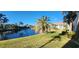 Waterfront view with palm trees, buildings, and green grass at 197 Tropicana Dr # 1512, Punta Gorda, FL 33950