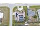 Aerial view of property with solar panels, screened-in pool, circular driveway, and outlined boundary at 23309 Hartley Ave, Port Charlotte, FL 33954
