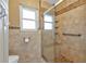 Bright bathroom with a glass shower, window, and stylish neutral-toned tile at 23309 Hartley Ave, Port Charlotte, FL 33954