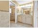 Bathroom featuring double sinks, a vanity and a glass shower enclosure at 23309 Hartley Ave, Port Charlotte, FL 33954