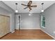 Neutral bedroom with beautiful hardwood floors, fan, and natural light at 23309 Hartley Ave, Port Charlotte, FL 33954