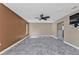 Bedroom featuring tiled floors, a large window and a black ceiling fan at 23309 Hartley Ave, Port Charlotte, FL 33954