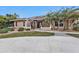 Single-story home with a circular driveway and palm trees at 23309 Hartley Ave, Port Charlotte, FL 33954