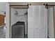 Convenient laundry room with washer, dryer, and barn doors at 23309 Hartley Ave, Port Charlotte, FL 33954