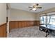 Office featuring wood paneling, a large window and tiled floors at 23309 Hartley Ave, Port Charlotte, FL 33954