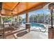 Inviting screened-in patio with wood ceiling overlooking a sparkling pool at 23309 Hartley Ave, Port Charlotte, FL 33954