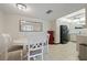 Dining area with white table and chairs adjacent to the kitchen at 25188 Marion Ave # A108, Punta Gorda, FL 33950