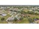 An aerial view of a neighborhood with single-Gathering homes, streets, and green spaces at 26090 Huanuco Dr, Punta Gorda, FL 33983