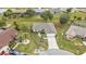 Aerial view of a house with a driveway and surrounding trees at 26090 Huanuco Dr, Punta Gorda, FL 33983