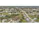 An aerial view of a residential neighborhood with homes, streets, trees, and vacant lots at 26090 Huanuco Dr, Punta Gorda, FL 33983