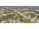 An aerial view of a residential neighborhood with homes, streets, trees, and vacant lots at 26090 Huanuco Dr, Punta Gorda, FL 33983