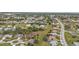 Aerial view of a residential area with houses, streets, trees, and empty plots of land at 26090 Huanuco Dr, Punta Gorda, FL 33983