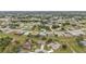 An aerial view of a residential neighborhood with houses nestled among trees and green spaces at 26090 Huanuco Dr, Punta Gorda, FL 33983