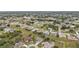 An aerial view of a residential neighborhood with houses, trees, green spaces, and a construction site at 26090 Huanuco Dr, Punta Gorda, FL 33983