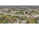 An aerial view of a residential neighborhood with houses nestled among trees and green spaces at 26090 Huanuco Dr, Punta Gorda, FL 33983