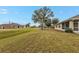 Large backyard with green grass and neighboring houses at 26090 Huanuco Dr, Punta Gorda, FL 33983