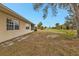 A view of the backyard and side of the house with a screened porch at 26090 Huanuco Dr, Punta Gorda, FL 33983