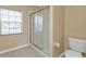 Bathroom featuring walk-in shower, toilet, and tiled floor at 26090 Huanuco Dr, Punta Gorda, FL 33983