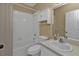 Bathroom with shower, toilet, sink, white tile, and window at 26090 Huanuco Dr, Punta Gorda, FL 33983