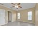Empty bedroom with tiled floor, ceiling fan, and windows with blinds at 26090 Huanuco Dr, Punta Gorda, FL 33983