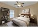 Bedroom with ceiling fan, carpeted floor, and a bed with a wooden headboard at 26090 Huanuco Dr, Punta Gorda, FL 33983