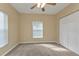 Empty bedroom with a ceiling fan, a window, and a closet at 26090 Huanuco Dr, Punta Gorda, FL 33983