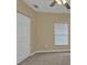 Empty bedroom corner with closet, window with blinds, and carpeted floor at 26090 Huanuco Dr, Punta Gorda, FL 33983
