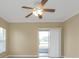 Empty bedroom with tile flooring, sliding glass doors, and a ceiling fan at 26090 Huanuco Dr, Punta Gorda, FL 33983