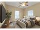 Bedroom with ceiling fan, two windows, carpeted floor, and a made bed at 26090 Huanuco Dr, Punta Gorda, FL 33983