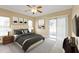 Bedroom featuring a ceiling fan, carpeted flooring, and sliding glass doors leading to the backyard at 26090 Huanuco Dr, Punta Gorda, FL 33983