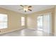 Empty bedroom with tile flooring, large windows, and sliding glass doors leading to a patio at 26090 Huanuco Dr, Punta Gorda, FL 33983