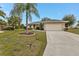 Front exterior view of a single-story home with a two-car garage at 26090 Huanuco Dr, Punta Gorda, FL 33983