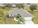Aerial view of home with gray shingle roof and attached garage at 26090 Huanuco Dr, Punta Gorda, FL 33983