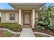 Close-up view of the front entrance, featuring a covered porch and decorative columns at 26090 Huanuco Dr, Punta Gorda, FL 33983