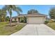 One-story home with a two-car garage and a driveway at 26090 Huanuco Dr, Punta Gorda, FL 33983