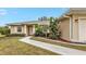 Front exterior view of a single-story home with a walkway leading to the entrance at 26090 Huanuco Dr, Punta Gorda, FL 33983