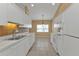 Well-lit kitchen with white cabinetry and stainless steel sink at 26090 Huanuco Dr, Punta Gorda, FL 33983