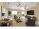 Living room with high ceilings, tile flooring, large windows, and modern furnishings at 26090 Huanuco Dr, Punta Gorda, FL 33983
