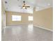 Spacious living room with tile flooring, large windows, and neutral-toned walls at 26090 Huanuco Dr, Punta Gorda, FL 33983