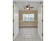 Empty office/den with tile floor, ceiling fan, and open double doors at 26090 Huanuco Dr, Punta Gorda, FL 33983
