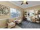 Home office or den with stylish furniture, artwork, and window with blinds at 26090 Huanuco Dr, Punta Gorda, FL 33983
