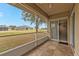 Tiled screened porch overlooking a grassy backyard at 26090 Huanuco Dr, Punta Gorda, FL 33983