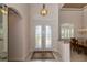 Foyer with double front doors and a view into the formal dining area at 26387 Madagascar Rd, Punta Gorda, FL 33983